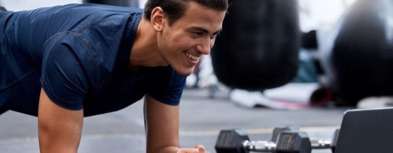 Exercise, laptop and personal trainer do virtual workout video on internet streaming