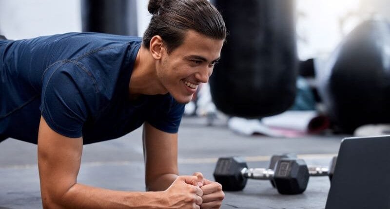 Exercise, laptop and personal trainer do virtual workout video on internet streaming